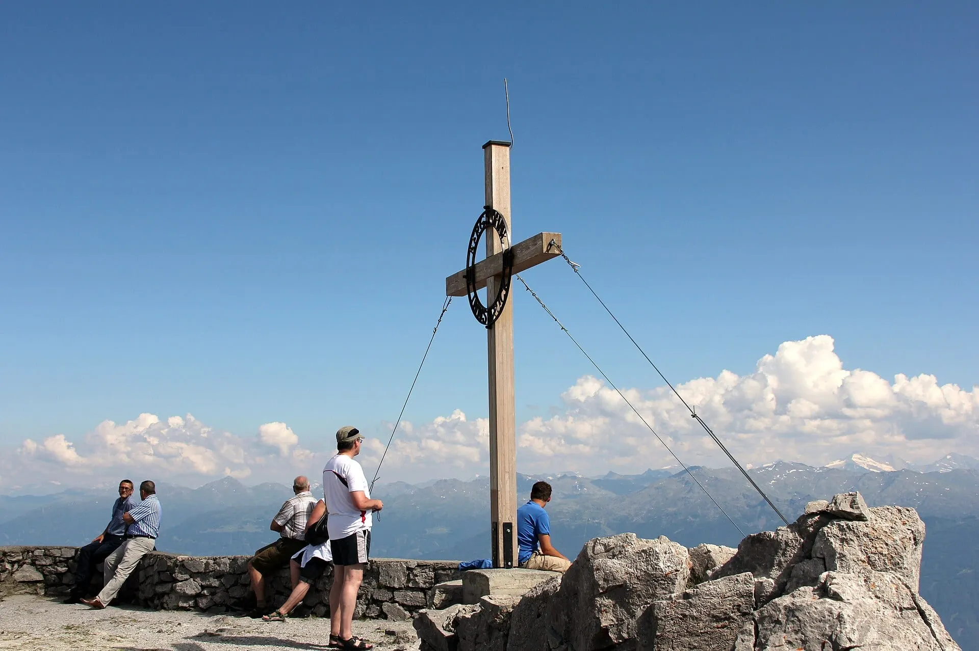 Walkers at the summit cross on the Nordkette above Innsbruck