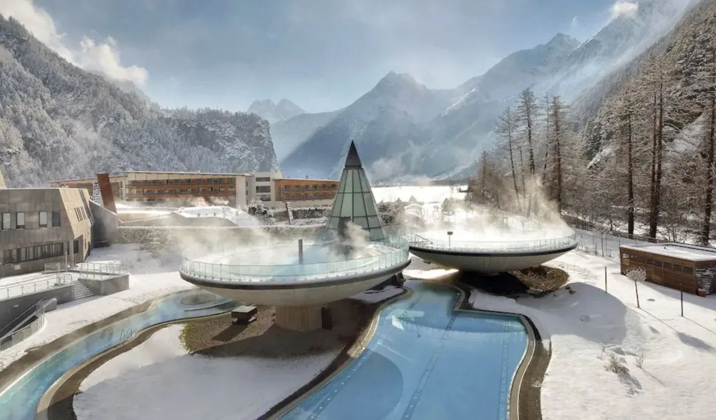Steaming Aqua Dome bowl pools in winter snow in the Ötztal