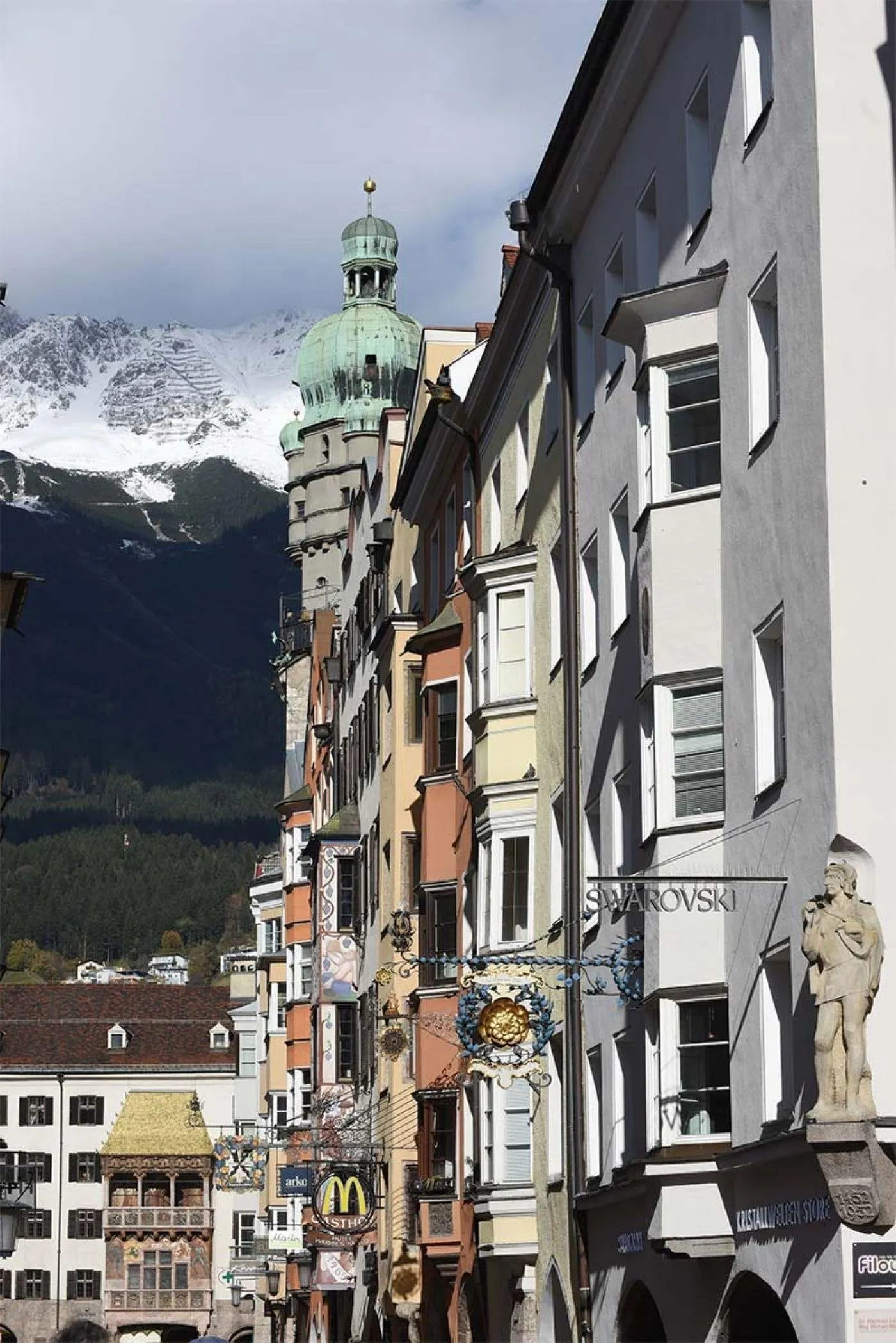 Swarovski sign on a painted old town façade with the Nordkette behind