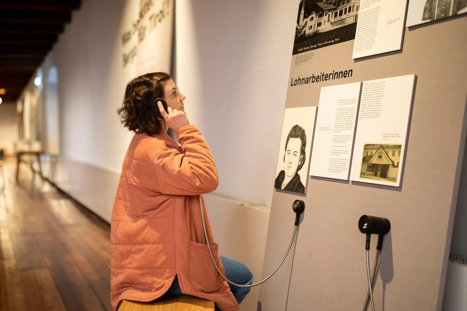 Besucherin an einer Hörstation in der Ausstellung im Museum im Zeughaus