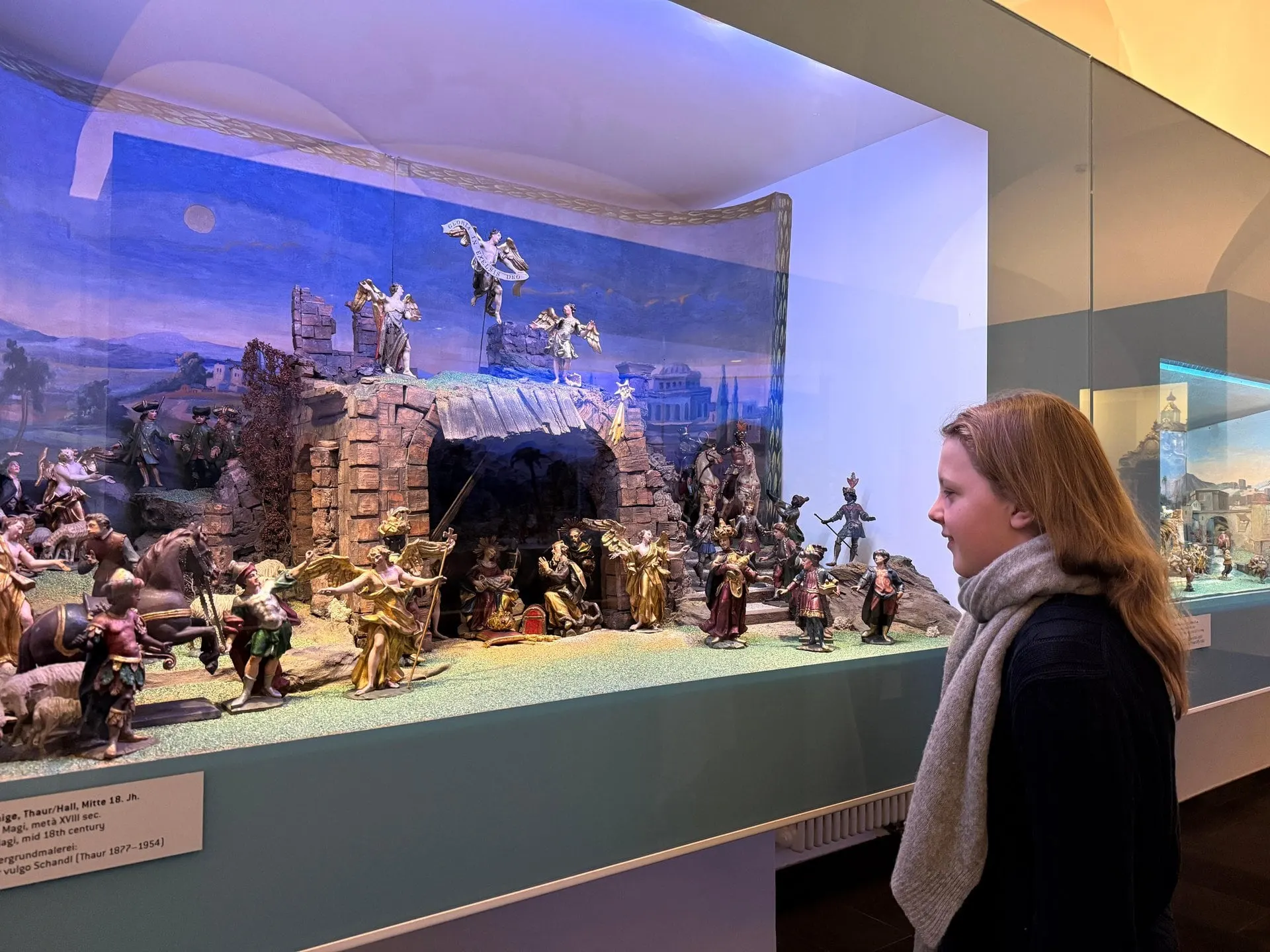 Visitor viewing a nativity scene in the Tyrolean Folk Art Museum