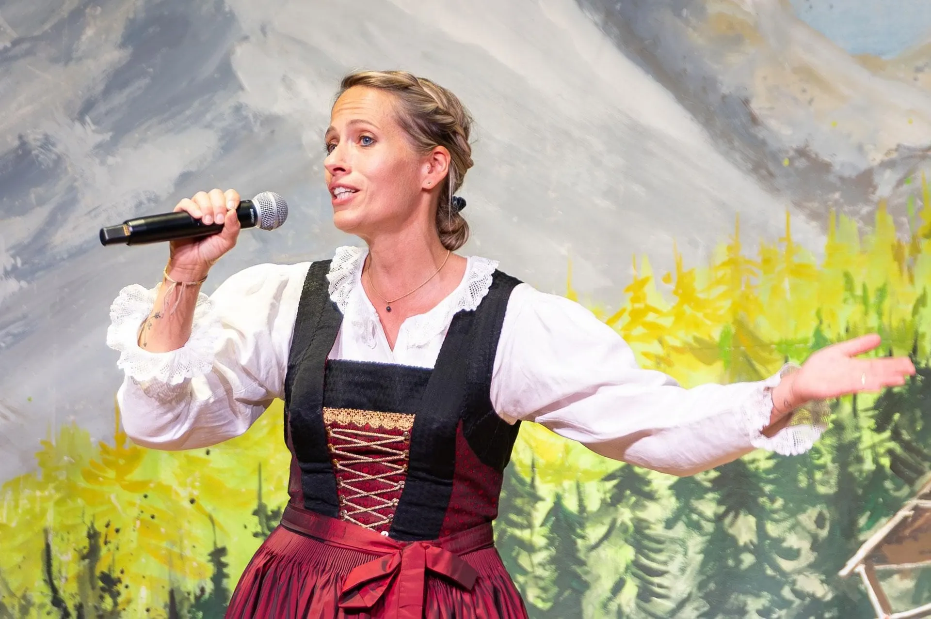 Singer in a dirndl performing at the Tyrolean evening in Innsbruck