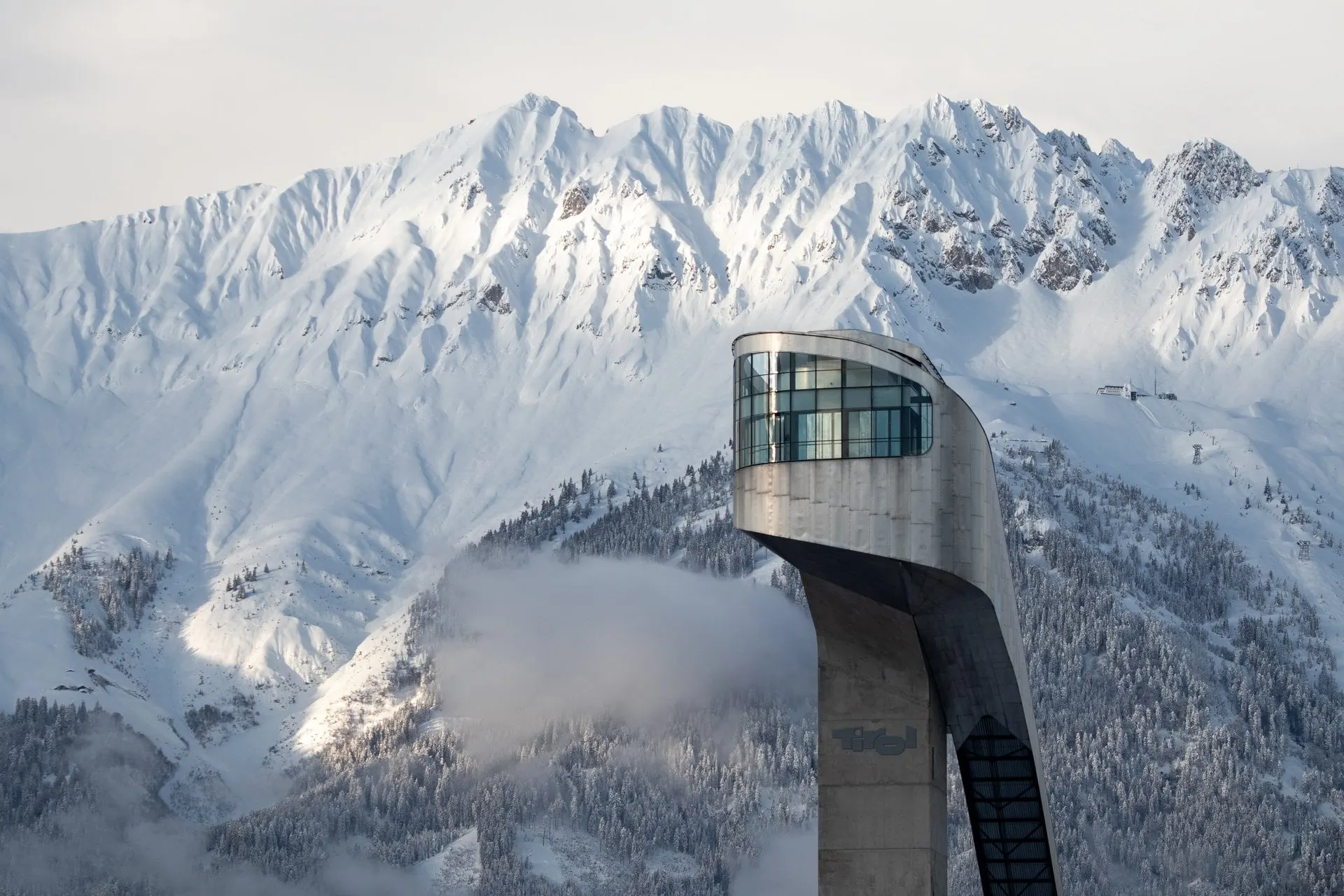 Bergisel tower with the snow covered Nordkette range behind