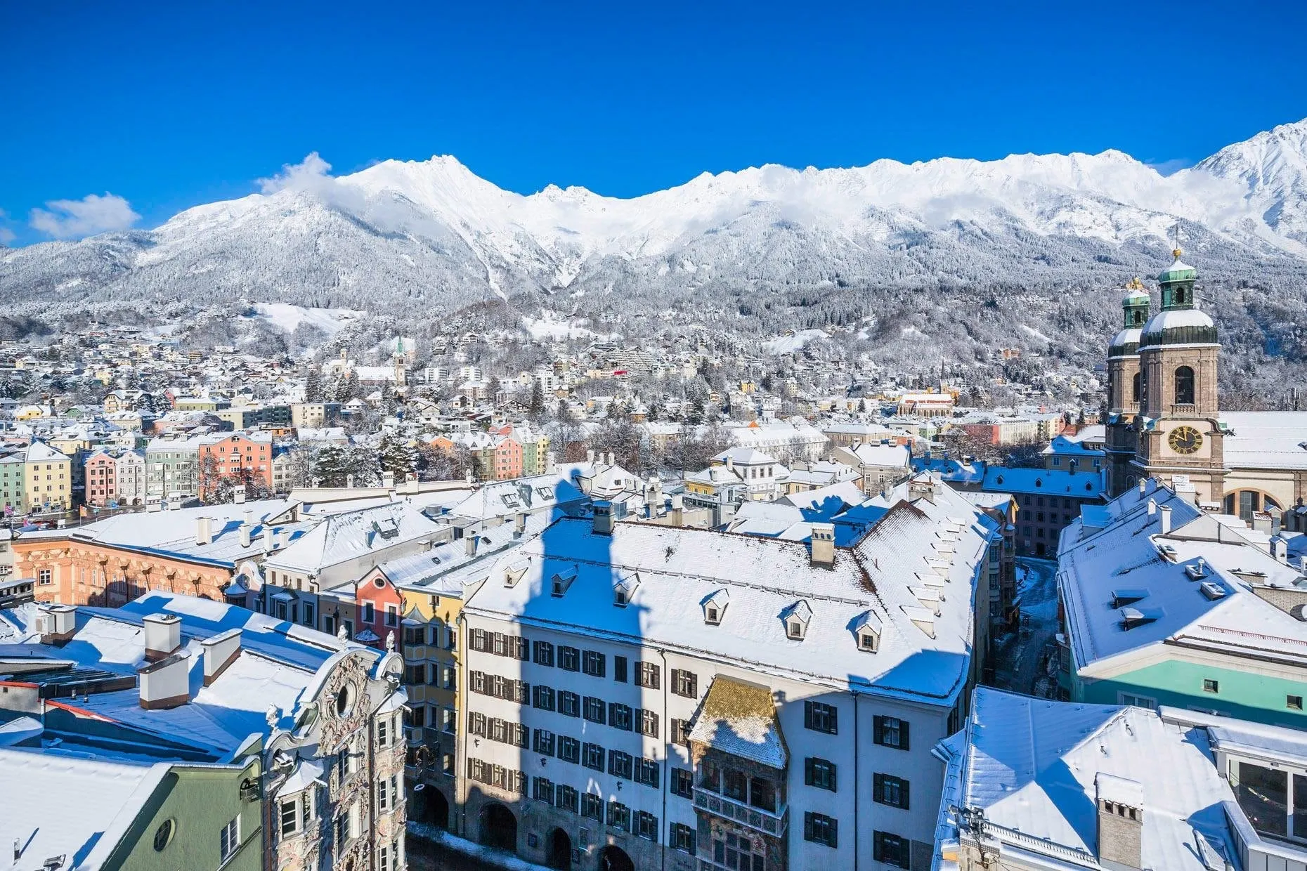 Snowy Innsbruck old town and cathedral from above with the Nordkette