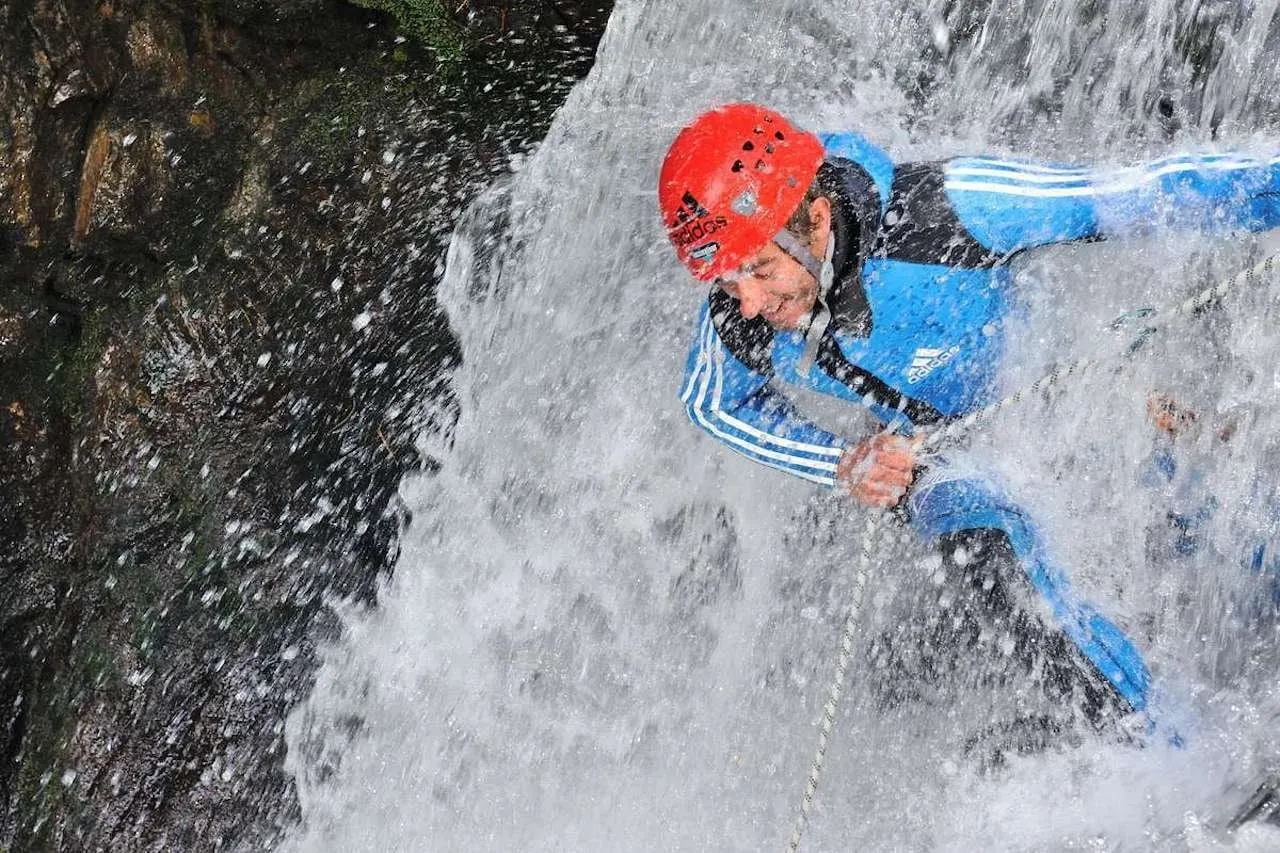 Canyoner abseiling through a waterfall