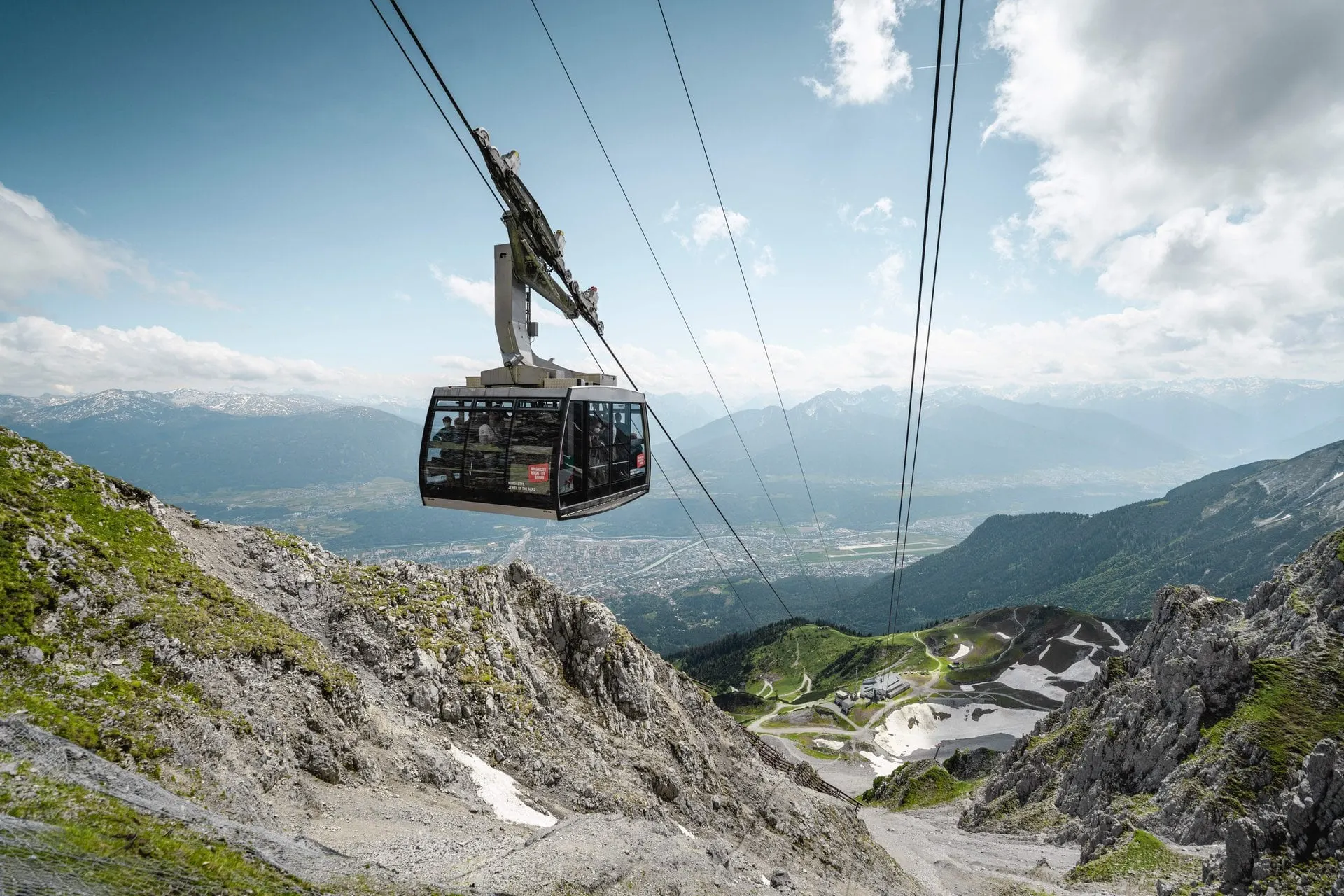 Nordkette cable car gondola above rocky slopes with the Inn Valley below