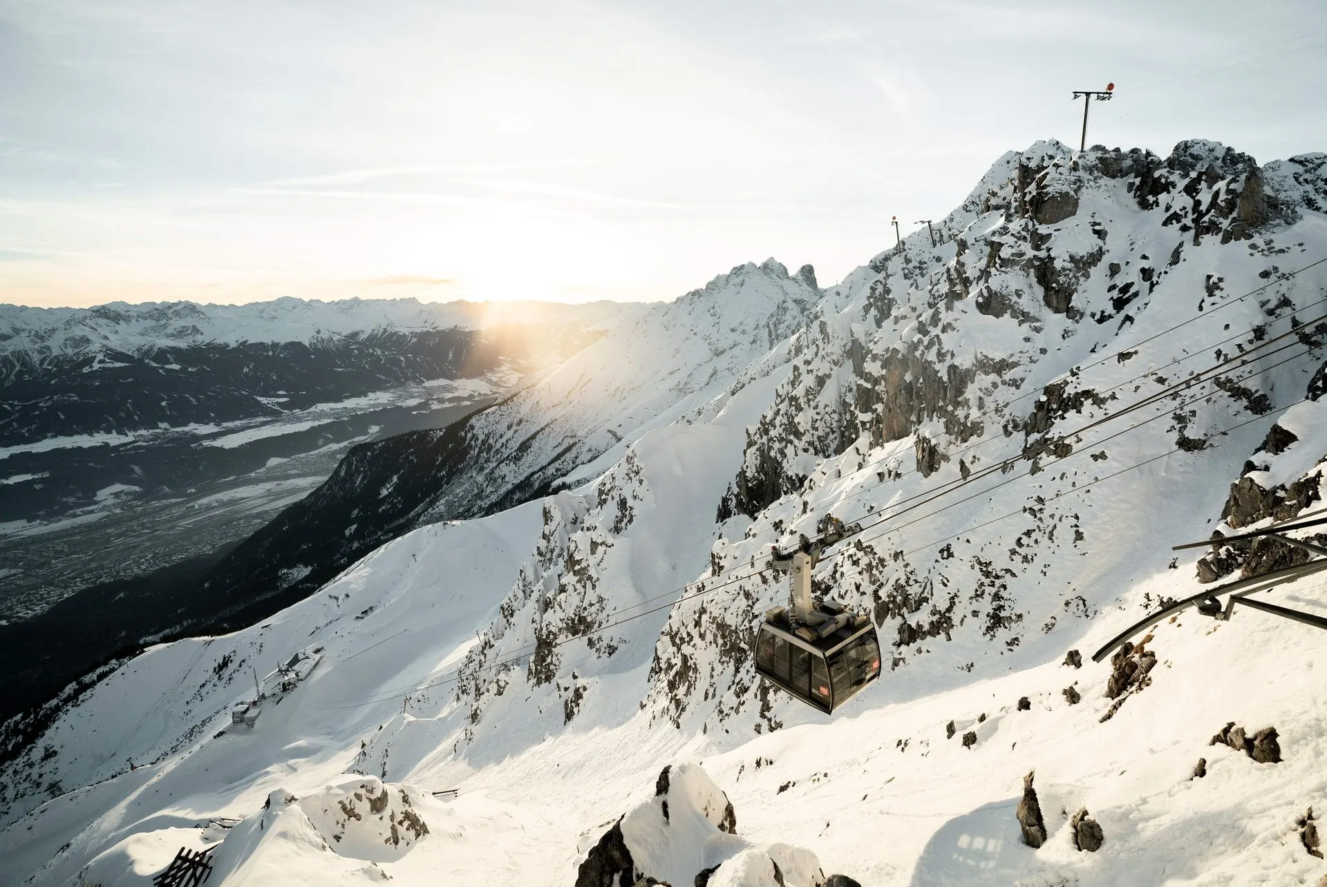 Nordkette cable car above snowy ridges in winter sunshine