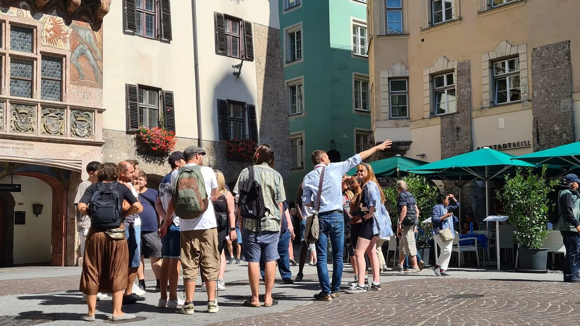 Guide pointing out sights to a group in Innsbruck old town