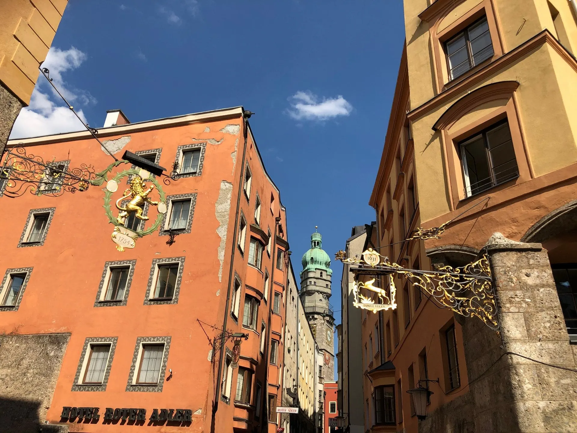 Painted houses with wrought iron signs and the City Tower dome