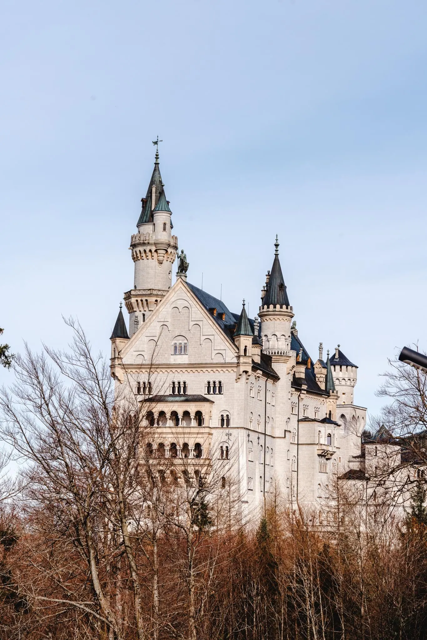 Neuschwanstein Castle towers against a pale sky