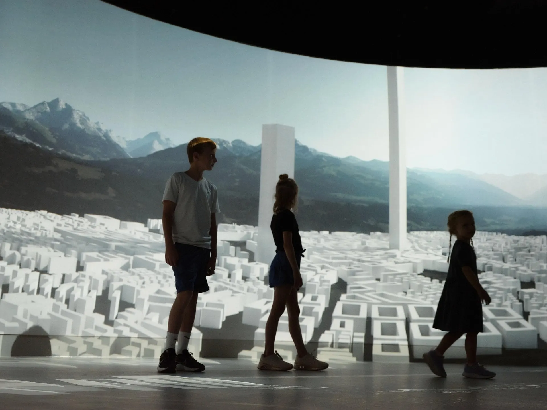 Visitors in a projected landscape room at Experience Tirol