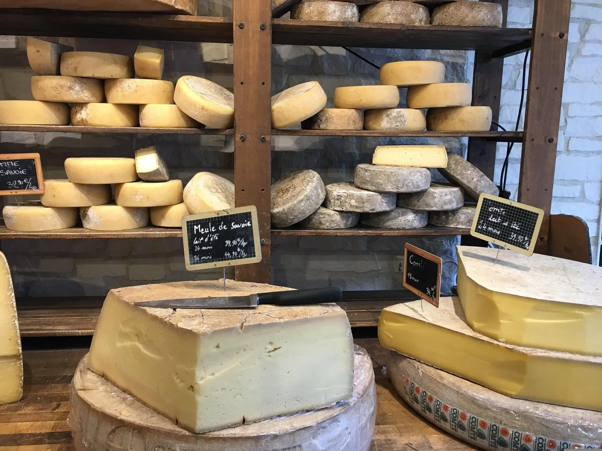 Wheels of Alpine cheese on shop shelves