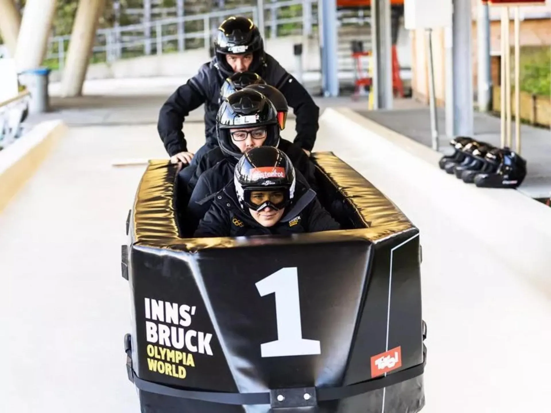Bobraft crew in helmets setting off at Olympia World Innsbruck